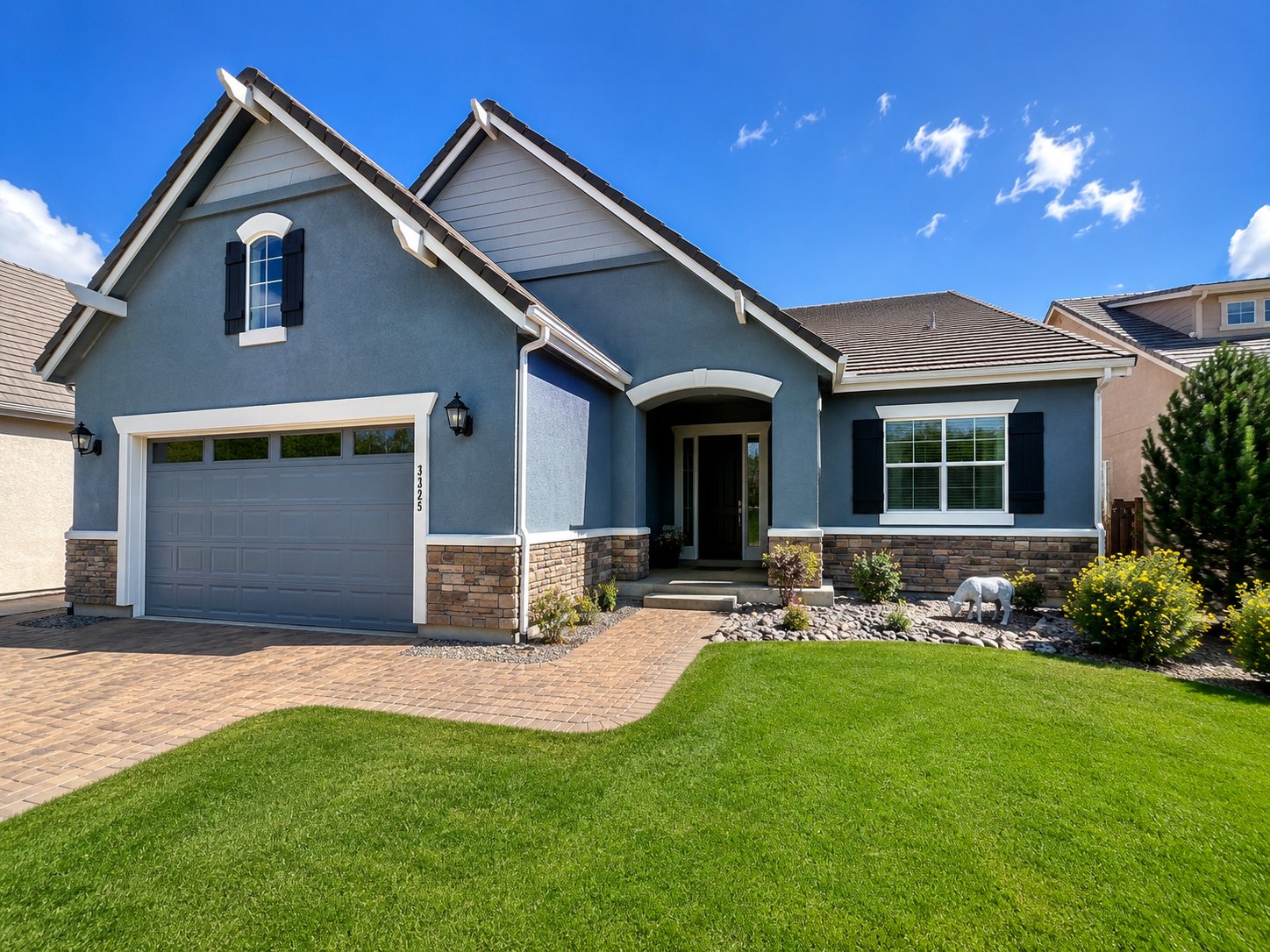 Exterior repaint of a slate-blue craftsman home with crisp white trim in Northern Nevada