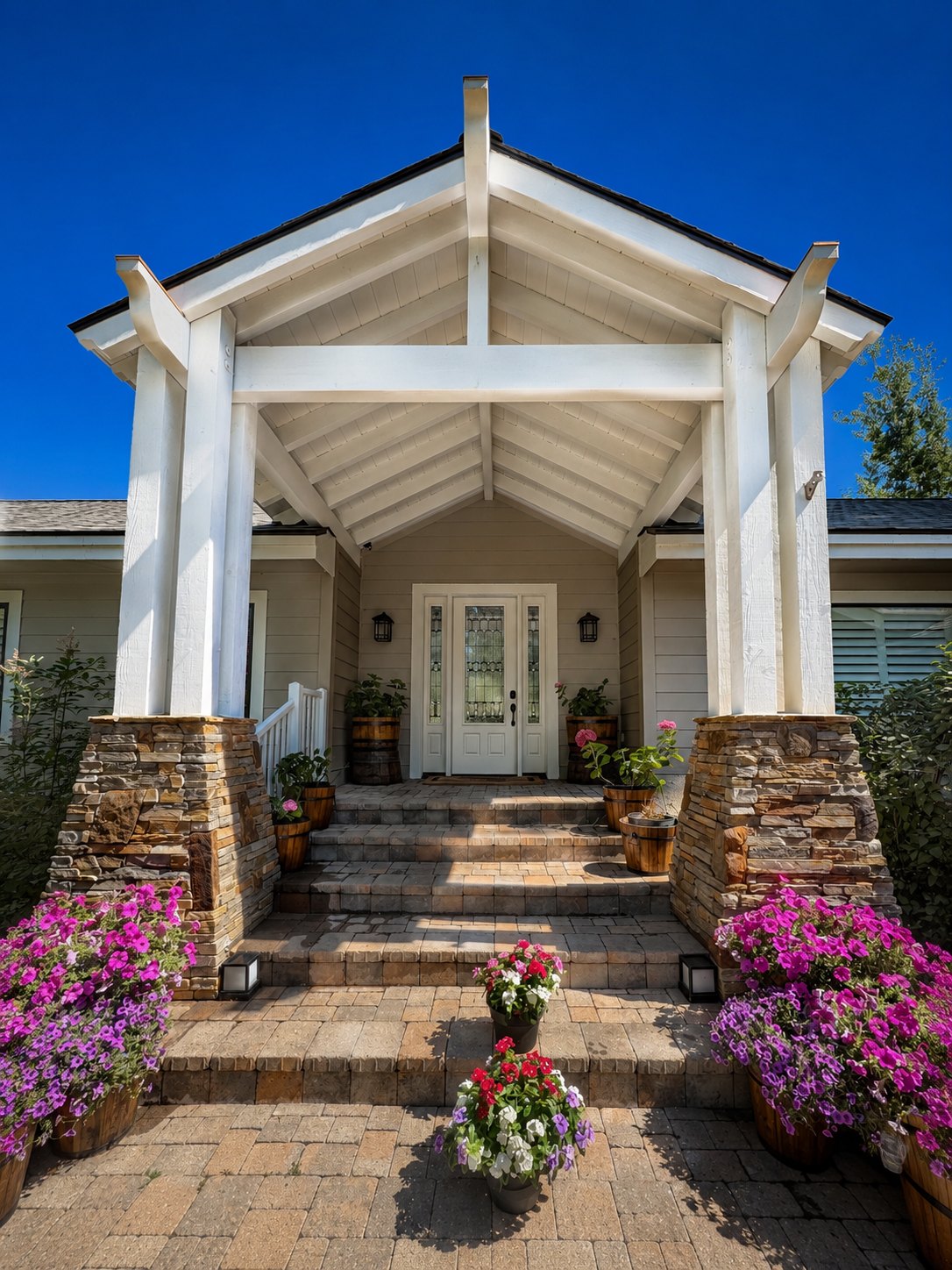 Exterior repaint of a covered front entry with stone columns and a paver walkway in Northern Nevada