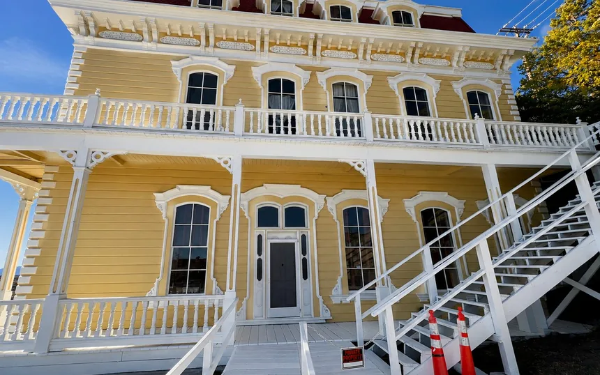 Historic yellow Victorian building with crisp white trim